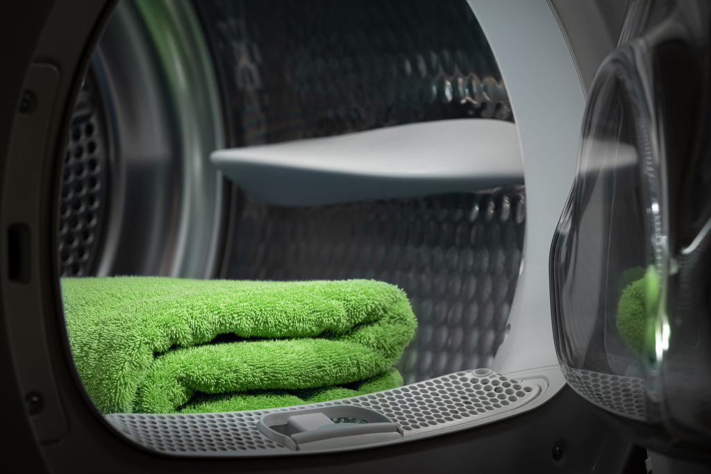 Folded Clean Green Towels In The Tumble Dryer. Clean Concept. La